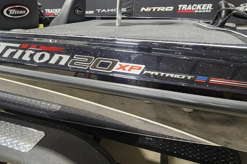 Slide: The Image of 2026 Triton 20XP Patriot boat with sleek design and branding details. - 12