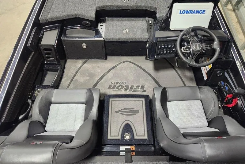 Slide: The Image of 2026 Triton 20XP Patriot boat interior with steering wheel and seating. - 7