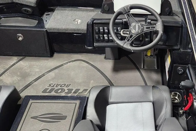 Slide: The Image of Interior of 2026 Triton 20XP Patriot boat with steering wheel and seating. - 9