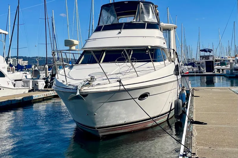 Slide: The Image of 2004 Carver 444 Cockpit Motor Yacht docked at marina under clear blue sky. - 1