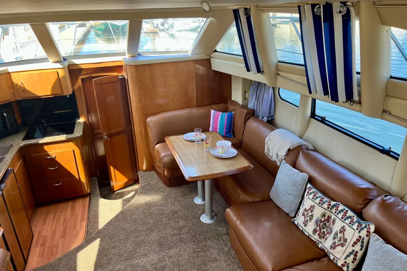 Slide: The Image of Luxurious interior of 2004 Carver 444 Cockpit Motor Yacht with cozy seating and dining area. - 10
