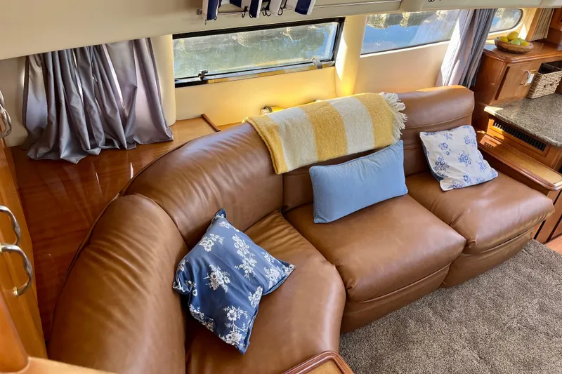 Slide: The Image of Luxurious interior of 2004 Carver 444 Cockpit Motor Yacht with leather seating and decorative pillows. - 13