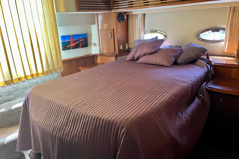 Slide: The Image of Luxurious bedroom interior of 2004 Carver 444 Cockpit Motor Yacht with cozy bedding. - 14