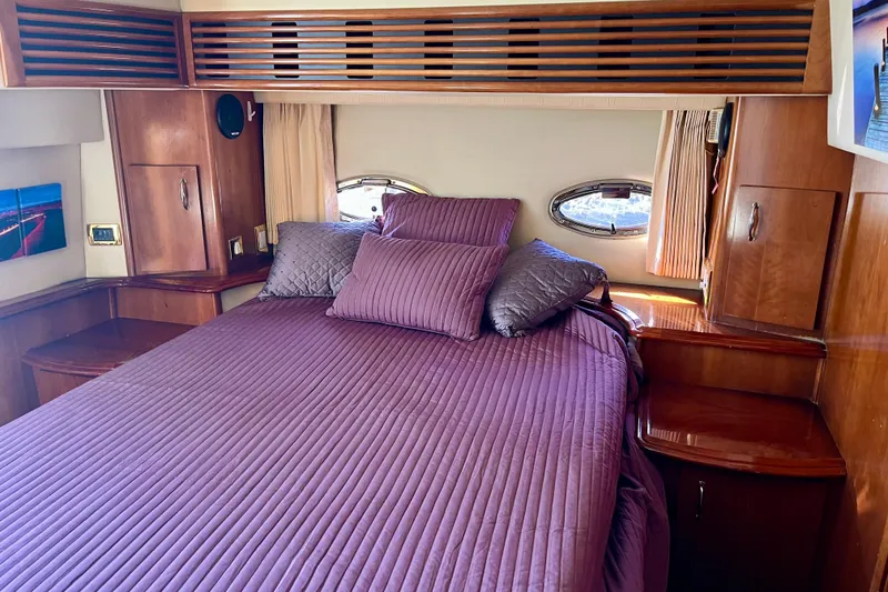 Slide: The Image of Luxurious bedroom interior of 2004 Carver 444 Cockpit Motor Yacht with purple bedding. - 15