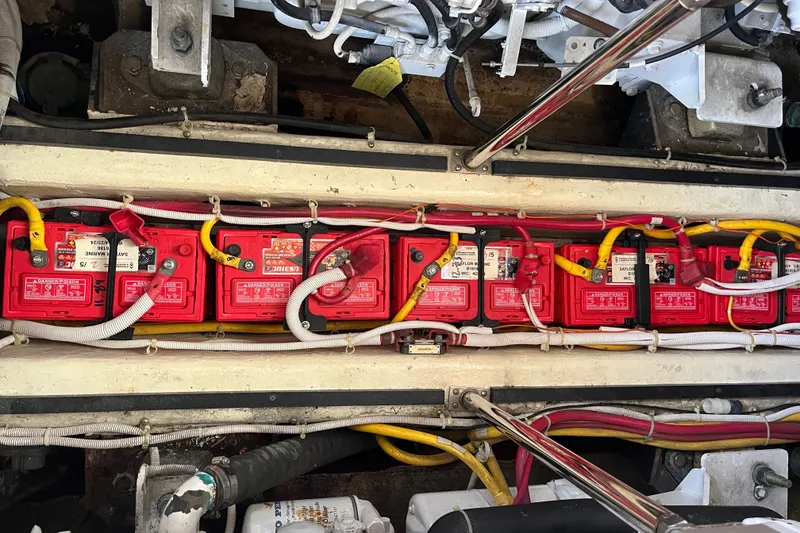 Slide: The Image of Battery compartment of a 2004 Carver 444 Cockpit Motor Yacht with red batteries and wiring. - 17