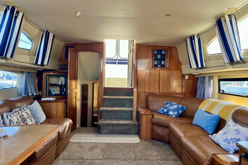 Slide: The Image of Luxurious interior of 2004 Carver 444 Cockpit Motor Yacht with leather seating and nautical decor. - 2