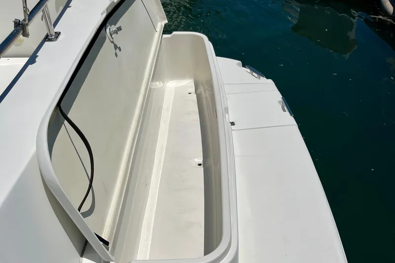 Slide: The Image of 2004 Carver 444 Cockpit Motor Yacht deck detail with storage compartment. - 23