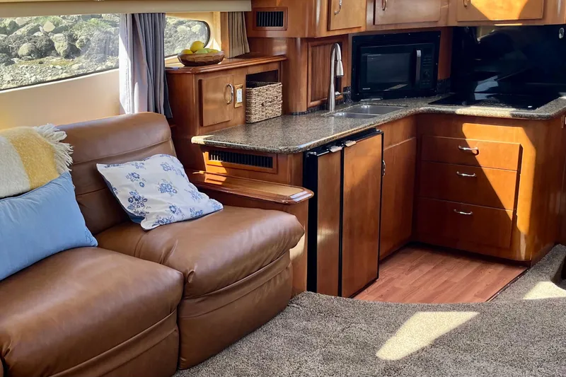 Slide: The Image of Luxurious interior of 2004 Carver 444 Cockpit Motor Yacht with cozy seating and kitchenette. - 8