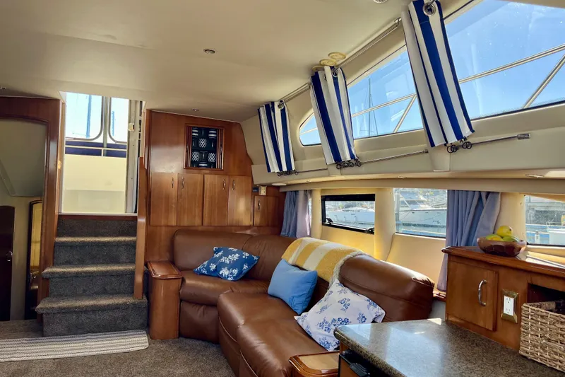 Slide: The Image of Luxurious interior of 2004 Carver 444 Cockpit Motor Yacht with leather seating and nautical decor. - 9