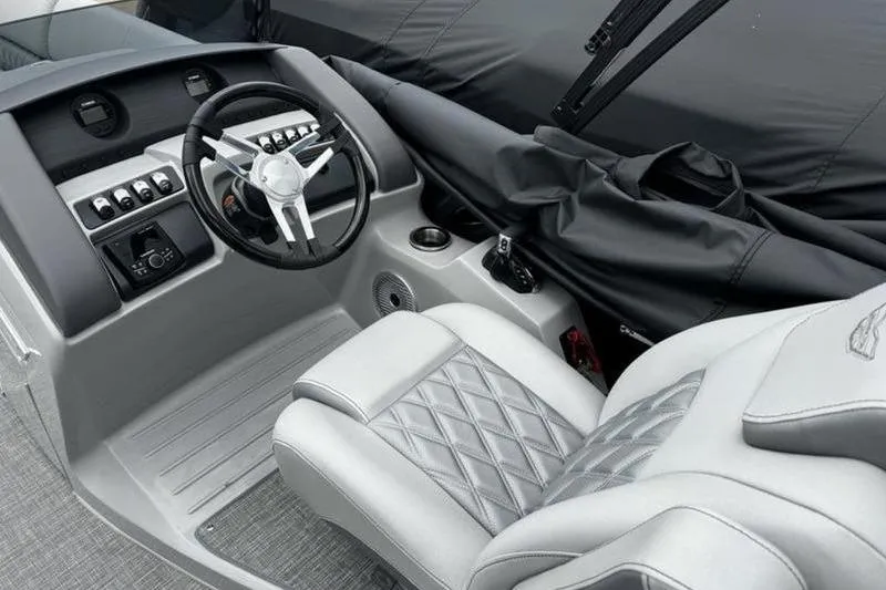 Slide: The Image of Luxurious helm of 2025 Bennington 26 LXSSB boat with modern controls and plush seating. - 10