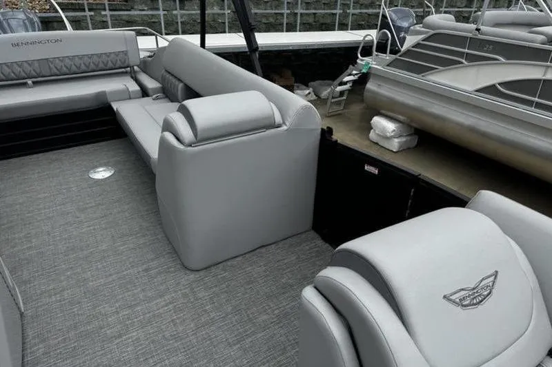 Slide: The Image of 2025 Bennington 26 LXSSB pontoon boat interior with gray seating and carpet. - 11