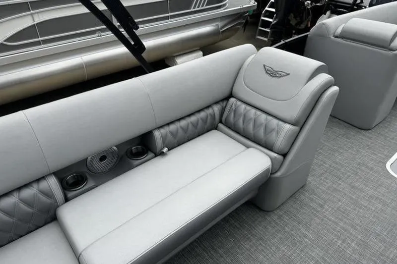 Slide: The Image of Luxurious seating on 2025 Bennington 26 LXSSB pontoon boat with quilted upholstery and cup holders. - 13