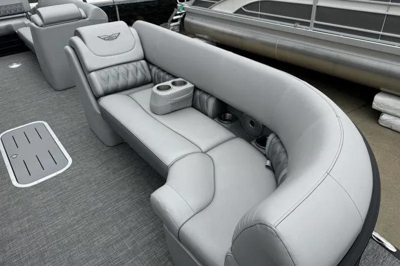 Slide: The Image of Luxurious seating on 2025 Bennington 26 LXSSB pontoon boat with gray upholstery and cup holders. - 6