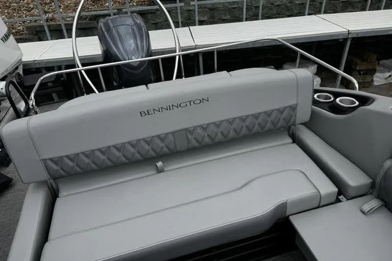 Slide: The Image of 2025 Bennington 26 LXSSB boat with luxurious gray seating and cup holders. - 8