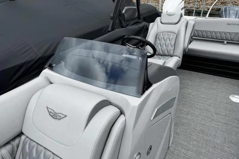 Slide: The Image of 2025 Bennington 26 LXSSB boat interior with luxurious seating and sleek dashboard design. - 9