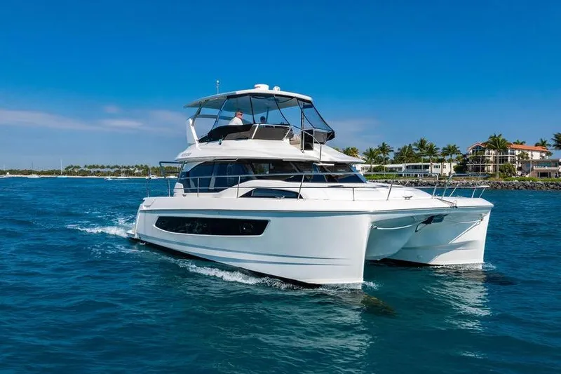 The Image of 2024 Aquila 44 Yacht cruising on blue ocean near tropical coastline. - 0