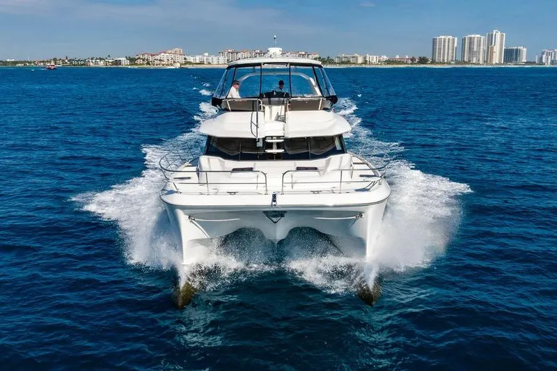 Slide: The Image of 2024 Aquila 44 Yacht cruising on blue ocean near city skyline. - 10