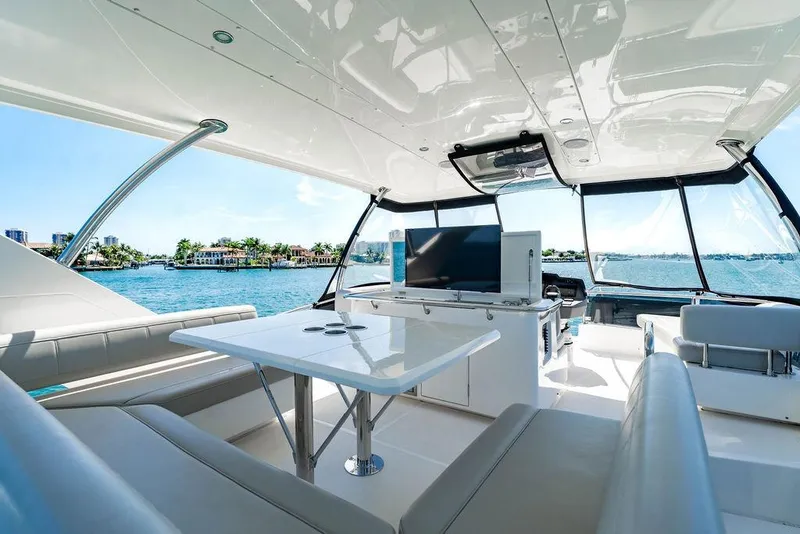Slide: The Image of Luxurious 2024 Aquila 44 Yacht interior with seating, table, and scenic ocean view. - 100