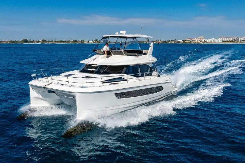 Slide: The Image of 2024 Aquila 44 Yacht cruising on open blue water. - 12