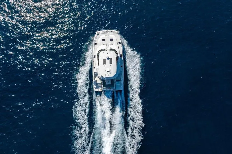 Slide: The Image of Aquila 44 Yacht 2024 cruising on open blue sea, aerial view. - 15