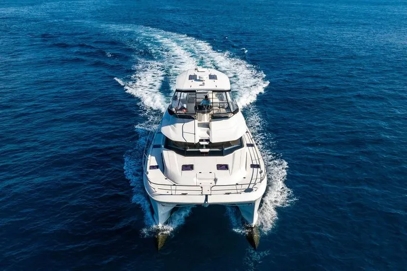 Slide: The Image of 2024 Aquila 44 Yacht cruising on open blue sea, aerial view. - 16