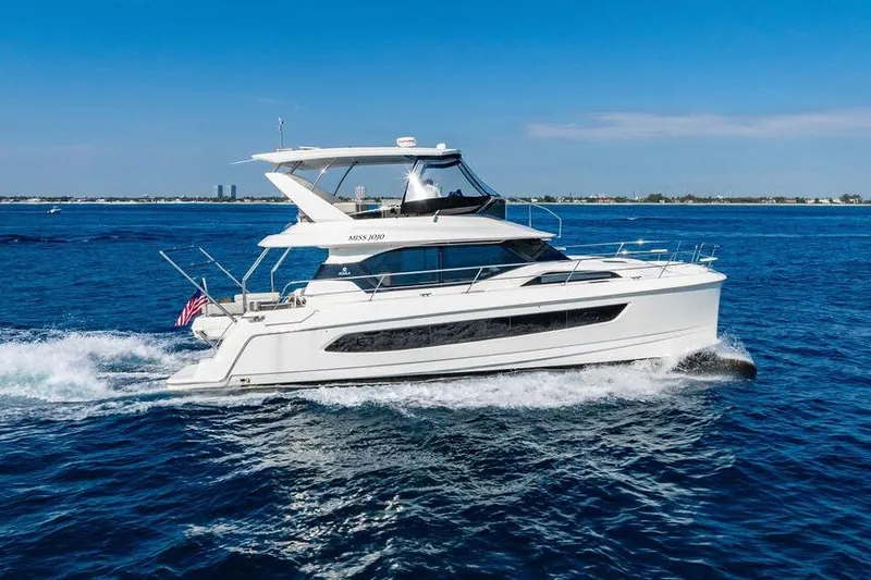 Slide: The Image of 2024 Aquila 44 Yacht cruising on open blue waters under clear skies. - 18