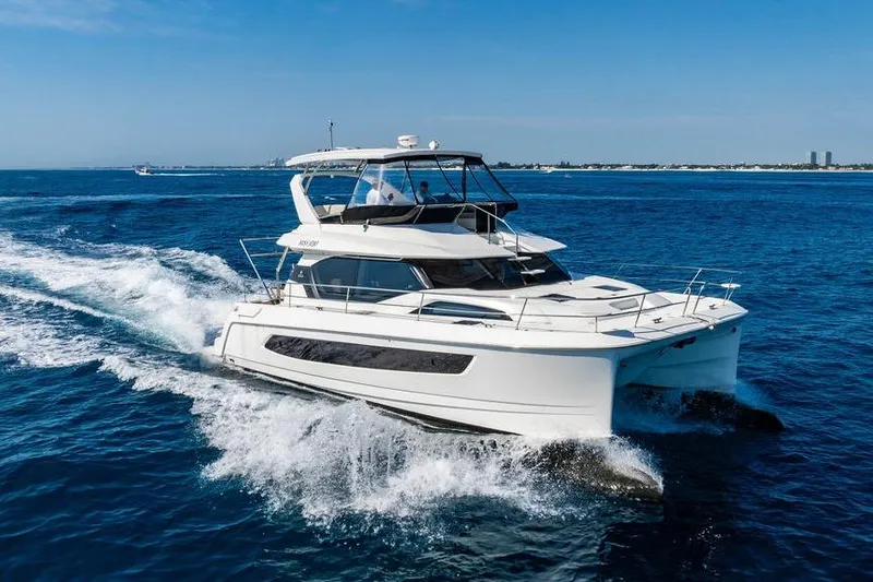 Slide: The Image of 2024 Aquila 44 Yacht cruising on open blue waters. - 19