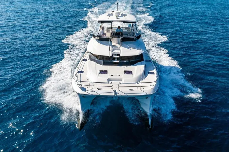 Slide: The Image of 2024 Aquila 44 Yacht cruising on open blue sea, aerial view. - 22