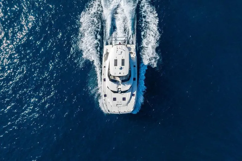 Slide: The Image of Aerial view of 2024 Aquila 44 Yacht cruising on open blue sea. - 23