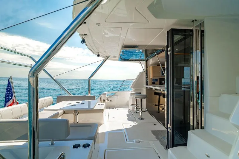 Slide: The Image of Luxurious 2024 Aquila 44 Yacht interior with ocean view, featuring seating and dining area. - 30
