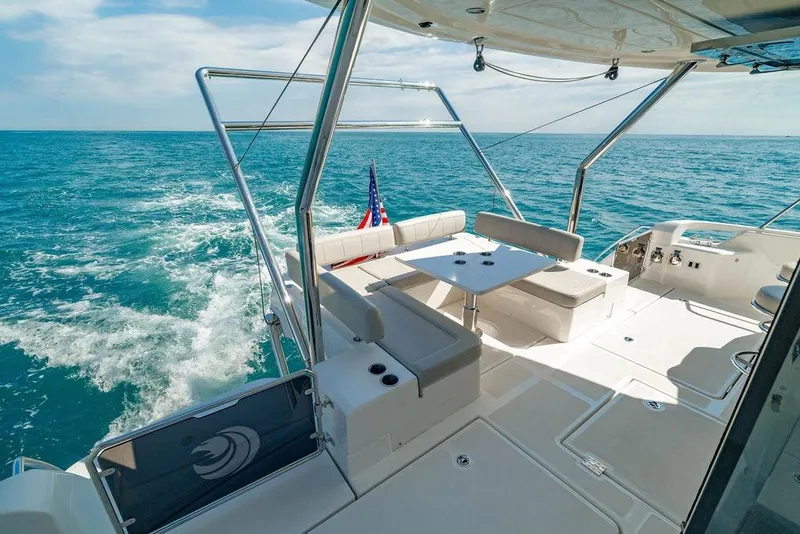 Slide: The Image of 2024 Aquila 44 Yacht cruising on open sea with spacious deck and seating area. - 35