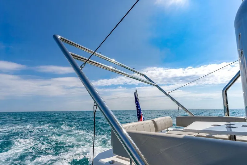 Slide: The Image of 2024 Aquila 44 Yacht cruising on open sea under clear blue sky. - 41