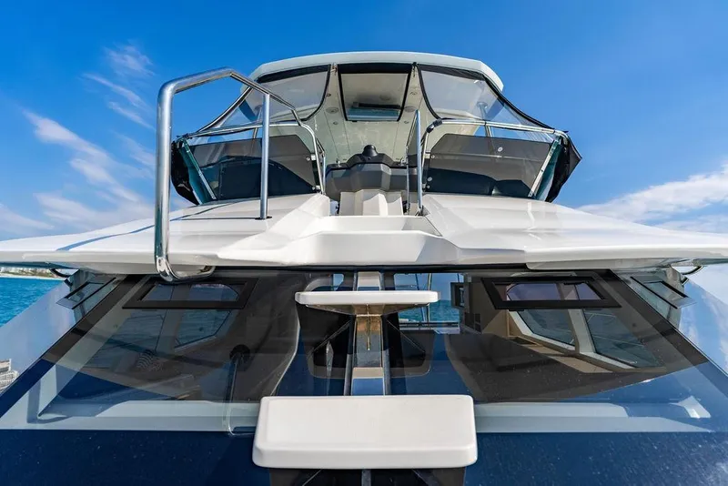Slide: The Image of 2024 Aquila 44 Yacht front view with sleek design and clear blue sky backdrop. - 50