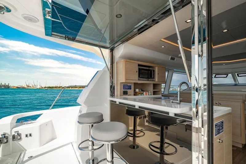 Slide: The Image of Interior view of 2024 Aquila 44 Yacht with modern kitchen and ocean backdrop. - 51