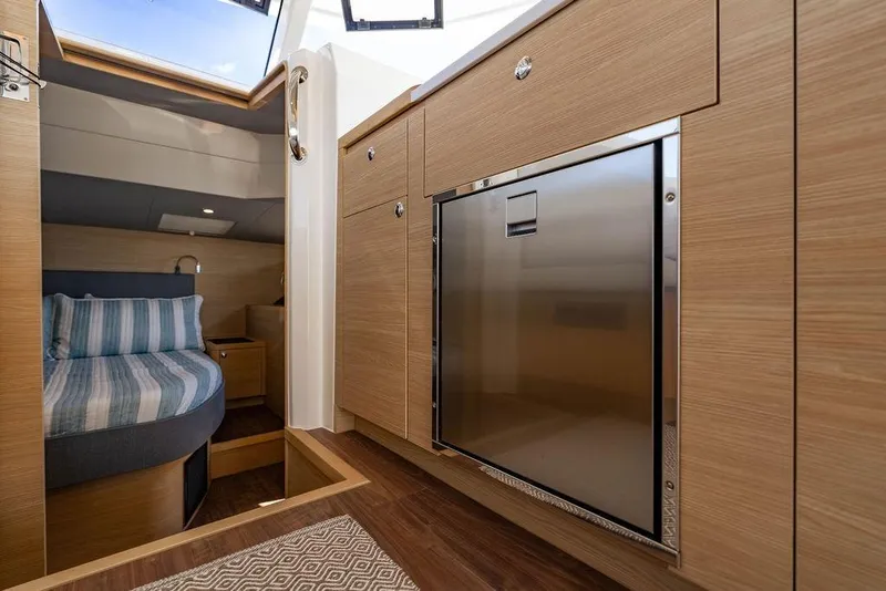 Slide: The Image of Interior of 2024 Aquila 44 Yacht featuring modern wood cabinetry and cozy sleeping area. - 60