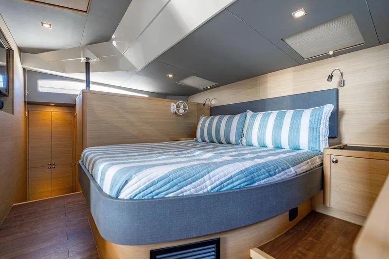 Slide: The Image of Luxurious bedroom interior of 2024 Aquila 44 Yacht with striped bedding and modern design. - 66