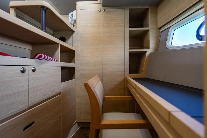 Slide: The Image of Interior of 2024 Aquila 44 Yacht featuring wooden cabinetry and a desk area. - 69