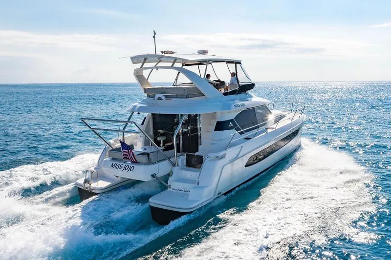 Slide: The Image of 2024 Aquila 44 Yacht cruising on open sea under clear skies. - 7