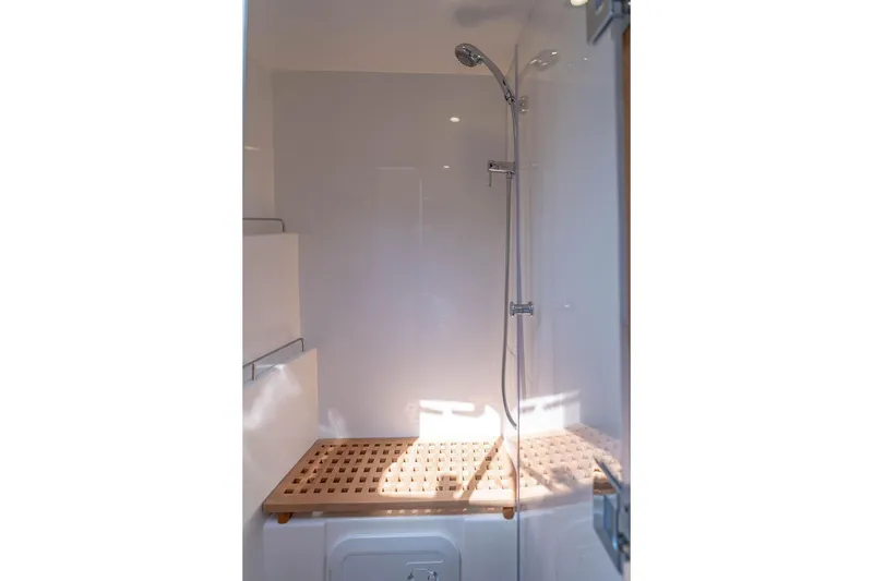Slide: The Image of Shower area in 2024 Aquila 44 Yacht with wooden bench and modern fixtures. - 73