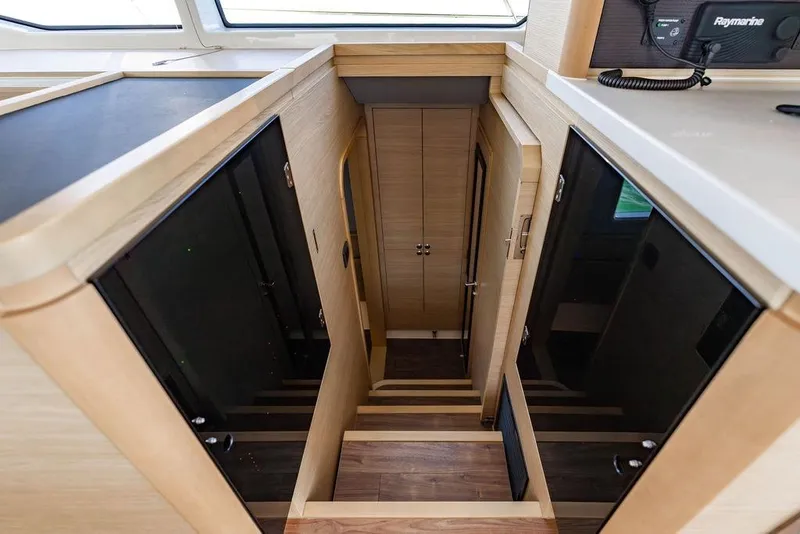 Slide: The Image of Interior view of 2024 Aquila 44 Yacht, featuring sleek wooden stairs and modern design. - 74