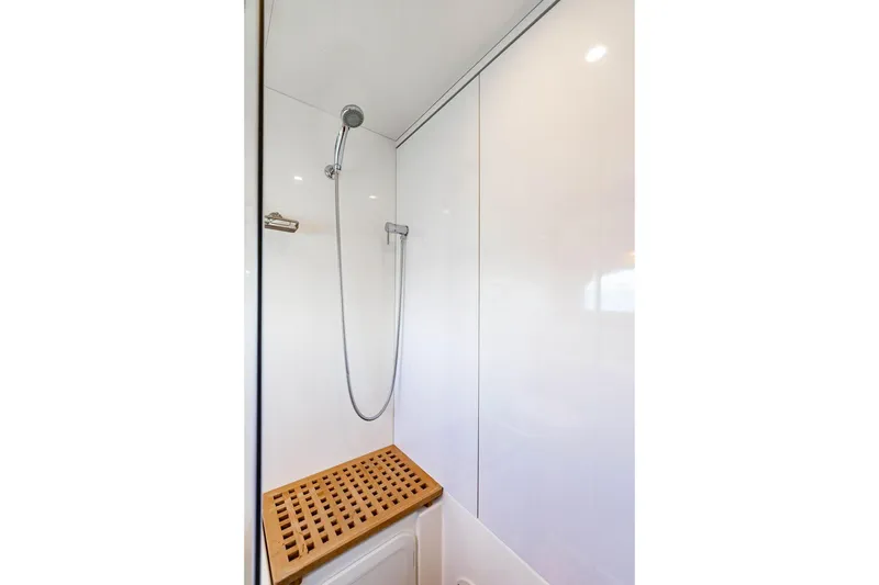 Slide: The Image of Shower area in 2024 Aquila 44 Yacht with sleek design and wooden bench. - 79
