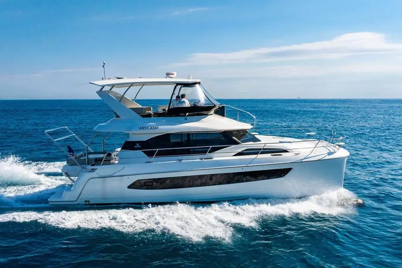 Slide: The Image of 2024 Aquila 44 Yacht cruising on open sea under clear blue sky. - 8