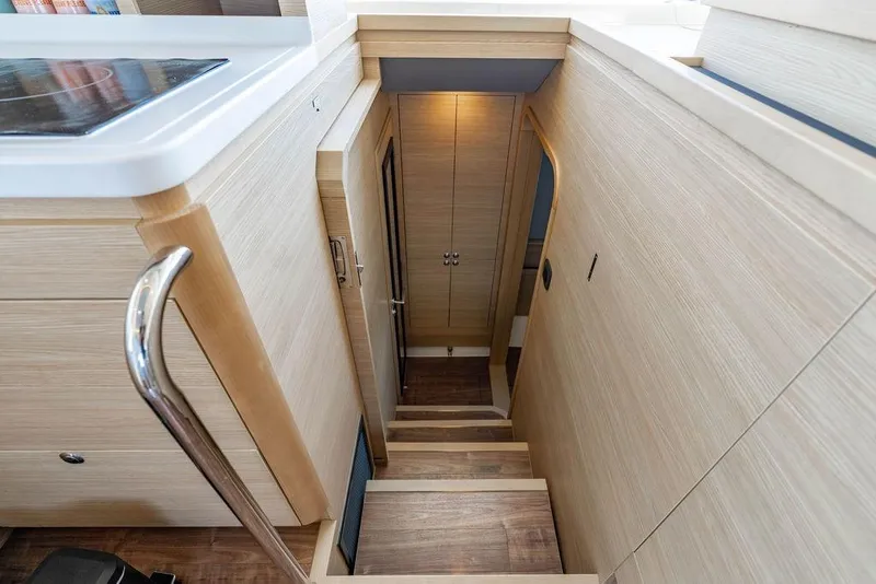 Slide: The Image of Interior staircase of 2024 Aquila 44 Yacht, featuring modern wood finish and sleek design. - 80