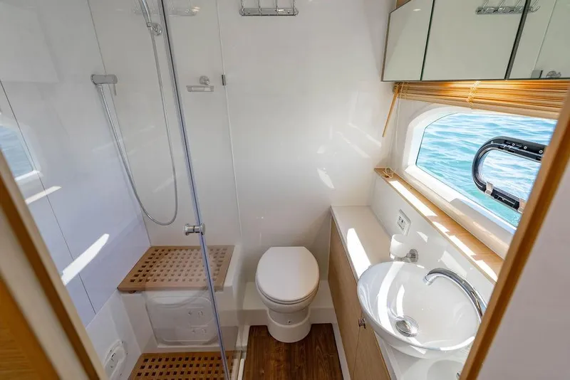 Slide: The Image of Luxurious bathroom on 2024 Aquila 44 Yacht with shower, sink, and ocean view. - 83