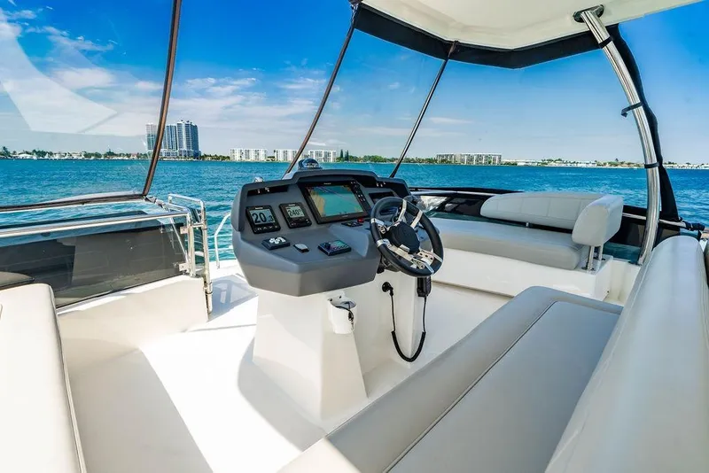 Slide: The Image of 2024 Aquila 44 Yacht helm with panoramic ocean view and modern navigation controls. - 87