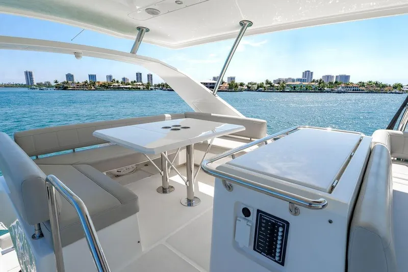 Slide: The Image of Luxurious 2024 Aquila 44 Yacht deck with seating, table, and ocean view. - 88