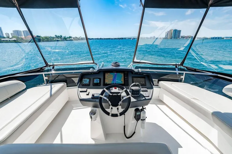 Slide: The Image of Cockpit view of 2024 Aquila 44 Yacht with modern navigation system and ocean backdrop. - 92
