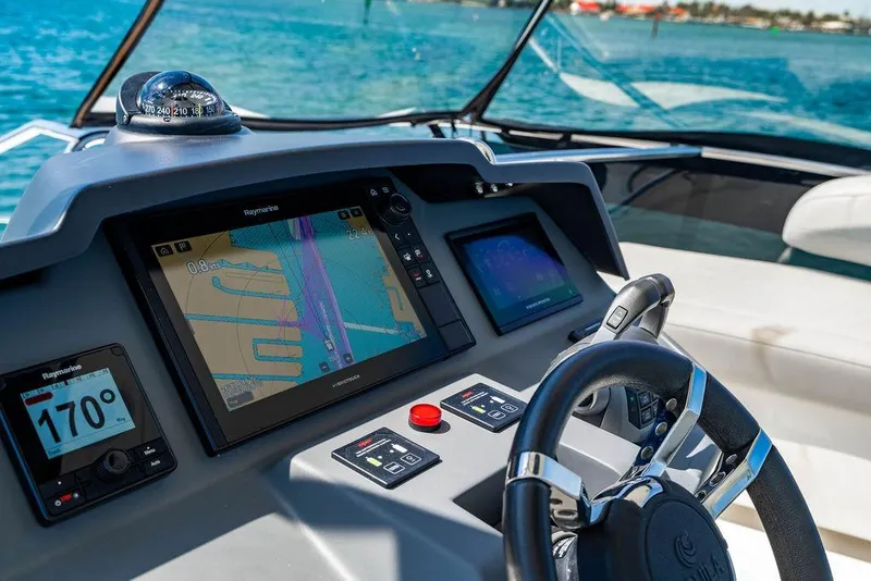 Slide: The Image of Cockpit of 2024 Aquila 44 Yacht with navigation screens and steering wheel. - 93