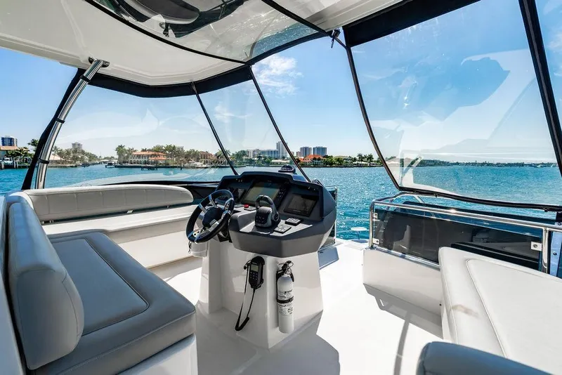 Slide: The Image of 2024 Aquila 44 Yacht interior with helm, luxurious seating, and ocean view. - 96