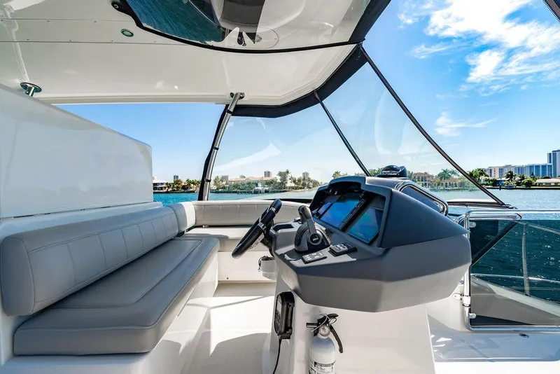 Slide: The Image of 2024 Aquila 44 Yacht helm with modern controls and panoramic water views. - 98